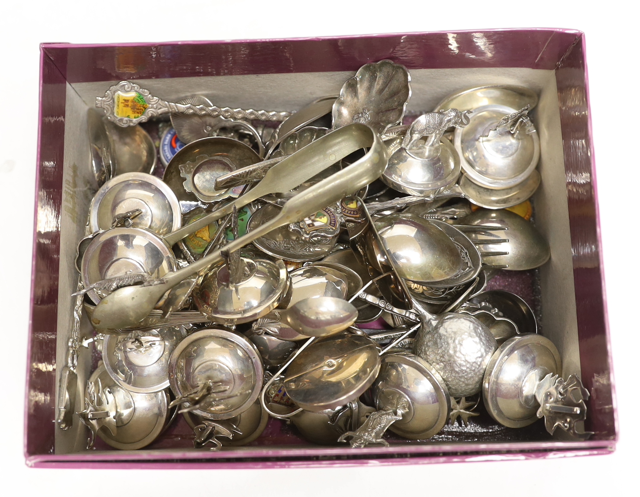 Twelve assorted Thai sterling mounted or 925 mounted menu holders, base diameter 36mm and a large quantity of plated or base metal flatware including souvenir spoons.